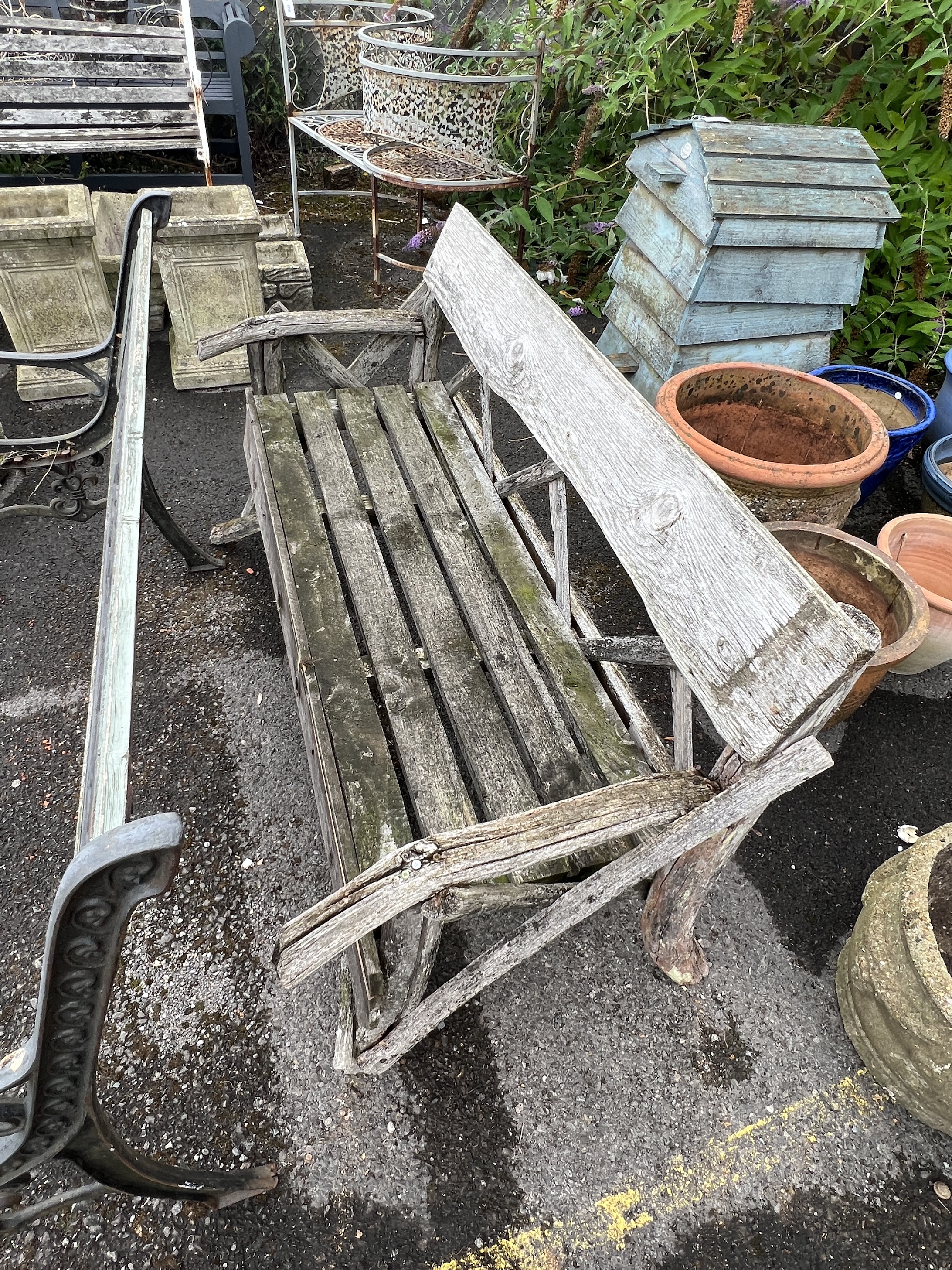 A rustic wooden garden bench, width 133cm, depth 58cm, height 74cm together with an aluminium garden table (in need of restoration)